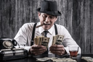 Picture of man smoking cigar and counting money.