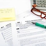Picture of reading glasses and tax form.