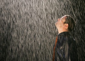 Picture of man standing in pouring rain