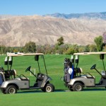 Picture of golf carts on course in desert.