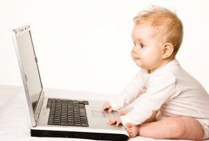 Picture of baby in front of computer.