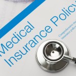 Picture of health insurance policy brochure with stethoscope