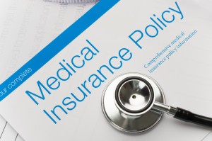 Picture of health insurance policy brochure with stethoscope