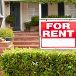 Picture of For Rent sign in front of rental house.