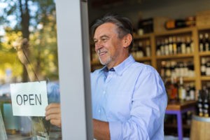 Picture of small business owner opening his wine shop
