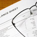 Balance sheet of a financial report with spectacles